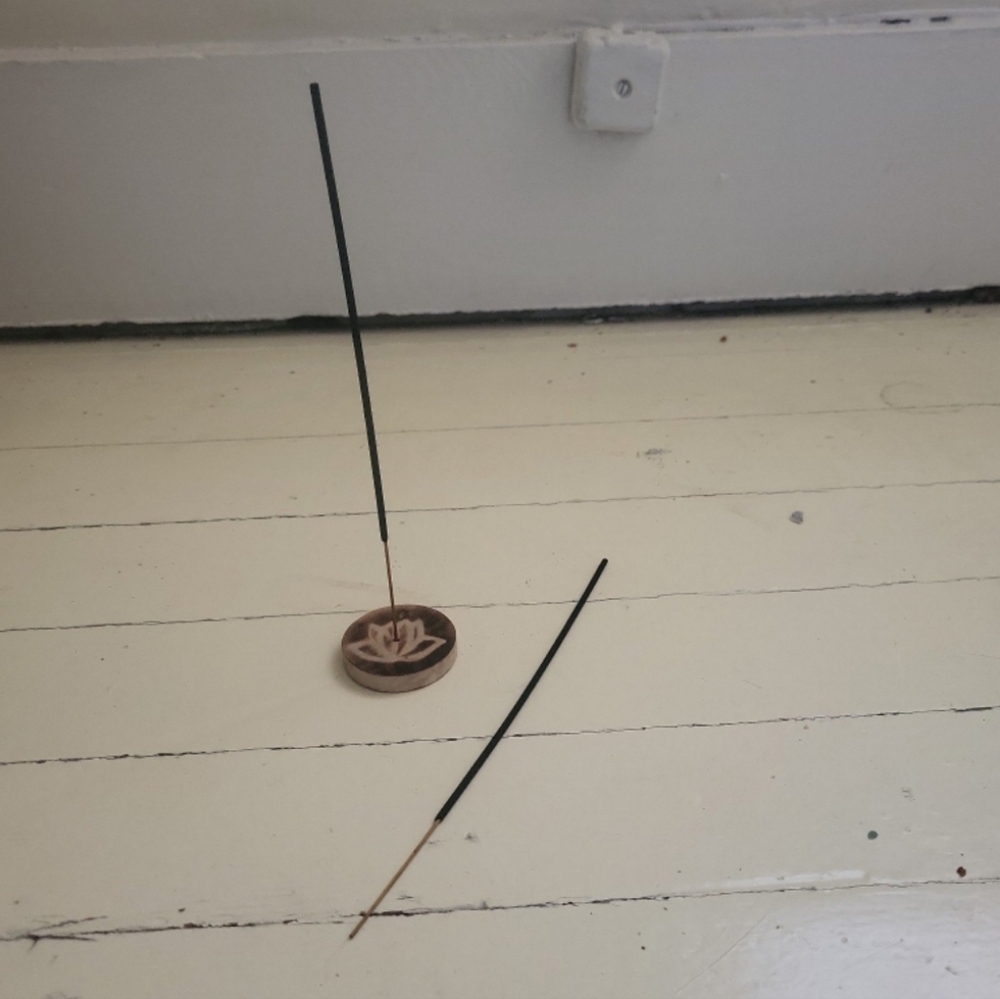 A small, wooden incense holder. Comes with 2 Palo Santo incense sticks